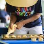 Teen student prepares amuse bouches for The Sylvia Center's Farm Event
