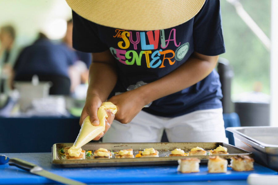 Teen student prepares amuse bouches for The Sylvia Center's Farm Event