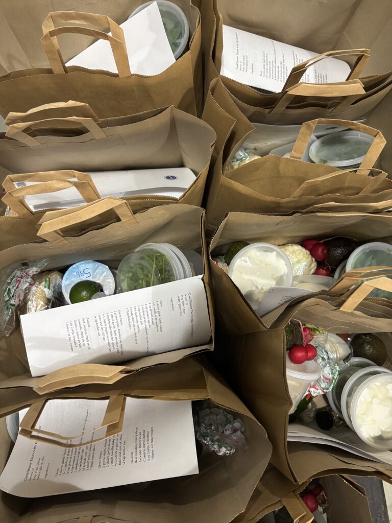 The Sylvia Center staff pack meal kit bags for Knights Table Pantry