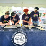 Annette Barlow helps teens from The Sylvia Center practice tasting